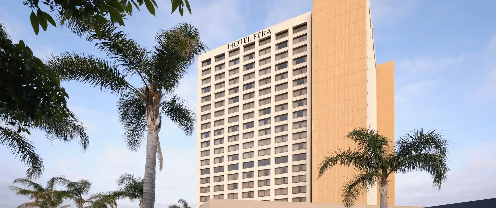 Hotel-Exterior (1) Hotel Fera building with palm trees.